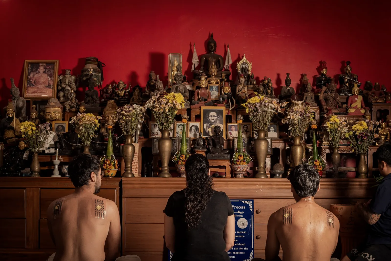 Clients sitting before the shrine during a Sak Yant ceremony