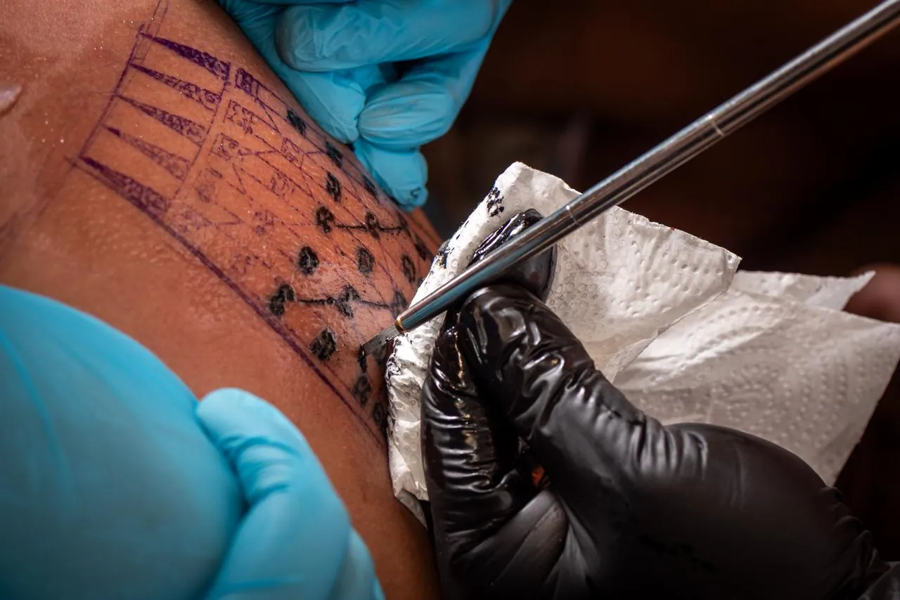 The skin is wiped clean throughout the tattooing