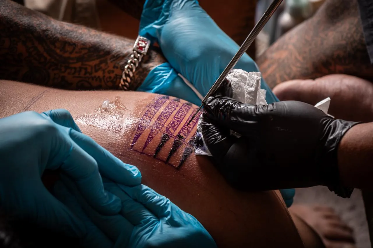 Five Lines Sak Yant being hand-poked with a traditional needle